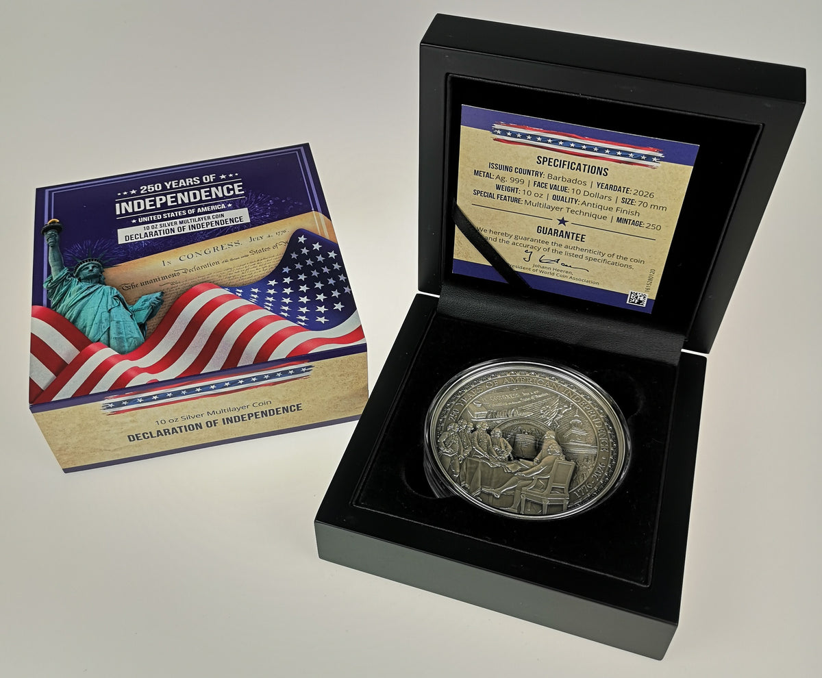 A silver commemorative coin displayed inside an open black presentation box, with its retail box and a specification card visible beside it on a light neutral background.