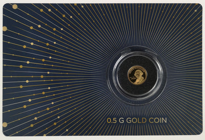 A 0.5 g gold coin displayed in a circular clear protective capsule, mounted on a dark navy blue card with gold radial lines.