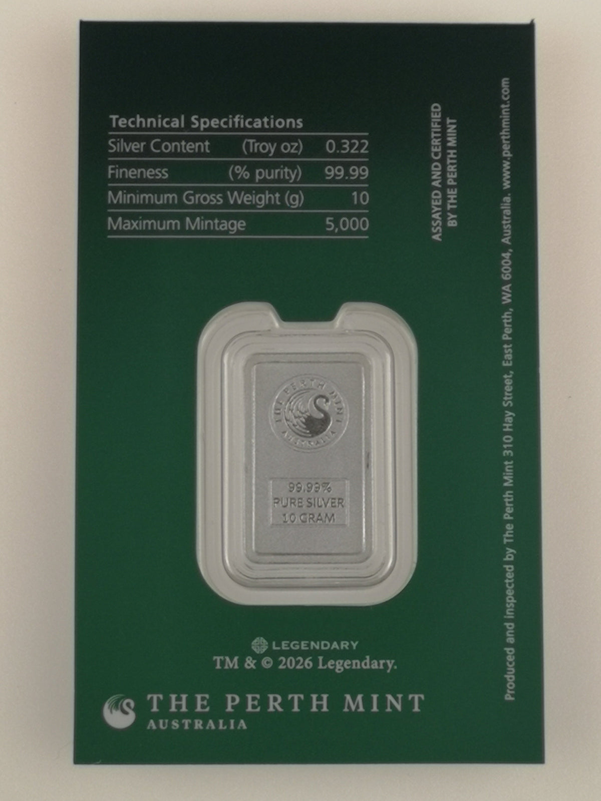 A silver bar in a clear protective capsule mounted on a dark green card from The Perth Mint.